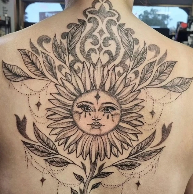 Ornamental sunflower tattoo with leaves
