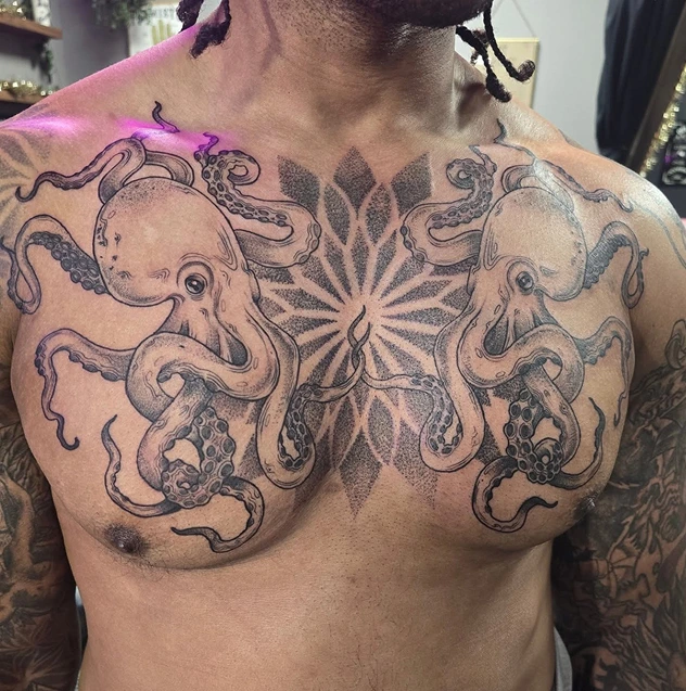 Chest tattoo featuring two squids with mandalas on each side